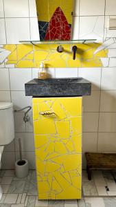 a yellow cabinet in a bathroom with a toilet at La Vigne - Han-sur-Lesse in Han-sur-Lesse +13 photos