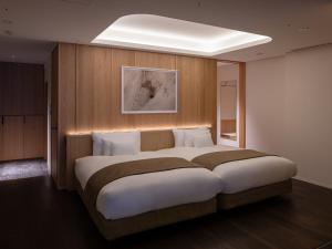 a bedroom with a large bed in a room at Lomä Central Peaks in Shinano
