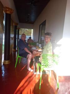a man and a woman sitting at a table at MarariBeachLaVista1 in Alleppey +23 photos