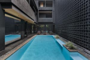 a swimming pool in the middle of a building at M4YA Berawa in Canggu