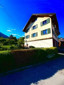 a white building with a brown roof at Casa Furlan in Calalzo