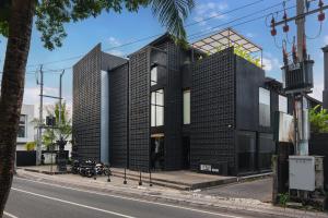 a black house on the side of a street at M4YA Berawa in Canggu