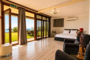 a bedroom with a bed and a living room at Palm Beach Şile Villa Hotels in Şile