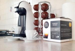 a coffee maker and a box on a kitchen counter at Dolomiti Alpine Homes - Appartamento Brenta in Giustino