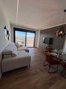 a living room with a couch and a table at Casa Emilia in San Javier