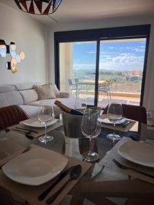 a living room with a table with plates and wine glasses at Casa Emilia in San Javier