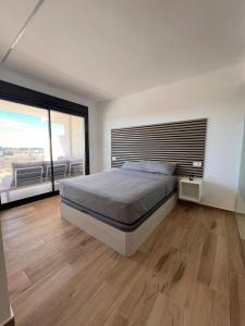 a bedroom with a large bed and a large window at Casa Emilia in San Javier +11 photos