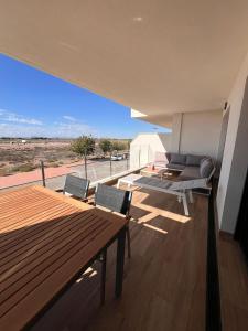 a balcony with a table and chairs and a view of the desert at Casa Emilia in San Javier