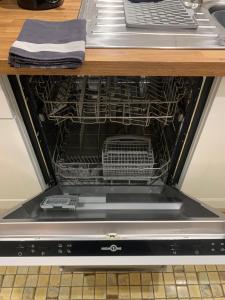 a dishwasher with its door open in a kitchen at Gite VILLENEUVE LA COMTESSE in Villeneuve-la-Comtesse +20 photos