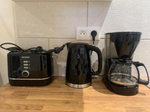 two coffee pots and a toaster on a counter at Gite VILLENEUVE LA COMTESSE in Villeneuve-la-Comtesse