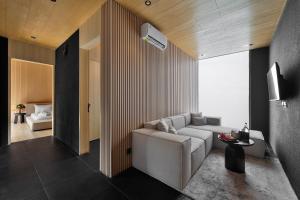a living room with a white couch and a table at M4YA Berawa in Canggu