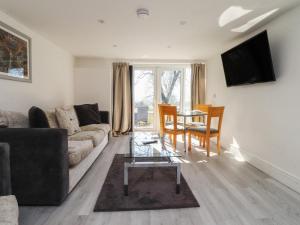 a living room with a couch and a table at Beacon Fell Cottage 2 in Preston