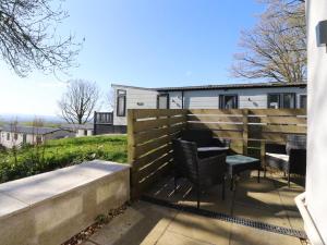 a patio with chairs and a fence at Beacon Fell Cottage 2 in Preston +4 photos