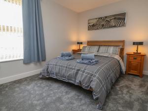 a bedroom with a bed and a window at Naseby House in Alfreton