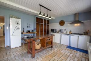 a large kitchen with a wooden table in it at L' ebénisterie in Tocane-Saint-Apre
