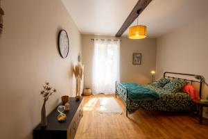 a living room with a bed and a couch at L' ebénisterie in Tocane-Saint-Apre