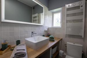 a bathroom with a white sink and a toilet at L' ebénisterie in Tocane-Saint-Apre +9 photos