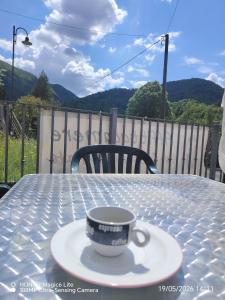 a coffee cup on a plate on a table at La casa delle fate in Lusevera +27 photos