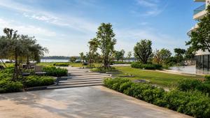a park with stairs and trees and a building at BTP Hotel Nakhon Phanom in Ban Noi Pho Kham