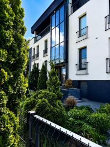 an apartment building with a garden in front of it at Centre Apartment in Druskininkai