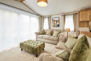 a living room with a couch and a chair at Host & Stay - Rose Lodge in Pocklington