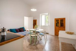a kitchen and living room with a table and chairs at Exclusive Maison Valentina in Monopoli +22 photos