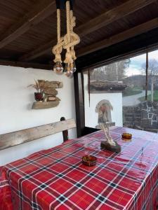 a room with a table with a plaid table cloth at Vintage House in Elena +13 photos