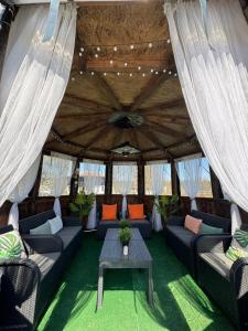 a living room with couches and a table in a tent at Vintage House in Elena