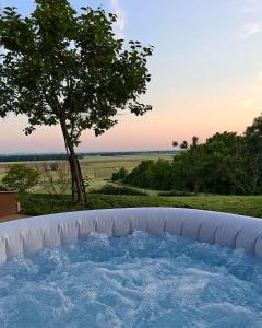 a large hot tub with a tree in the background at Počitniška hiša Kuferland in Dobrovnik