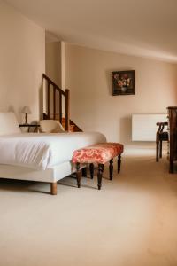 a bedroom with a bed and a bench and a table at Château senailhac in Tresses +15 photos