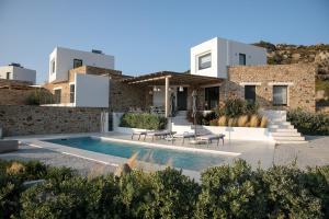 a villa with a swimming pool and a house at Villa Andalusia, Steps from Orkos Beach in Naxos Chora