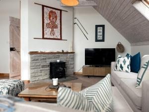 a living room with a couch and a fireplace at Dough Lodge in Lahinch