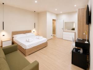 a bedroom with a bed and a living room at Villa Cliff in Aspra