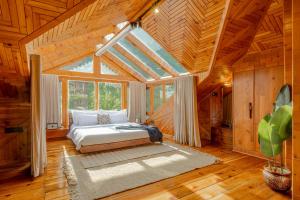 a bedroom with a bed and a large window at Padma Villa - Mountain Estate in Manali in Manāli