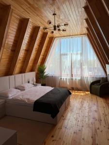 a bedroom with a bed and a large window at SOLAR Hotel and Restaurant in Gabala +81 photos