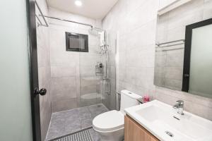 a bathroom with a shower and a toilet and a sink at Ranong Adventure Resort & Park in Ranong +22 photos