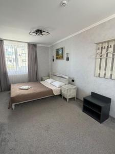 a bedroom with a bed and a table in it at Euro Hotel Hostel in Kovel