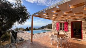 a patio with a table and chairs and a swimming pool at Harmony and Horizon villas in Athani