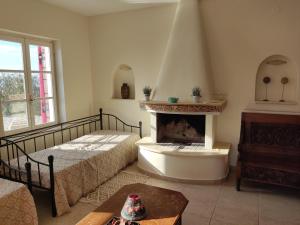 a living room with a bed and a fireplace at Harmony and Horizon villas in Athani