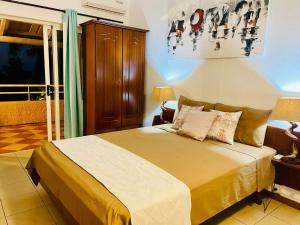a bedroom with a bed in a room at Secure villa in a quiet garden with pool in Albion +24 photos