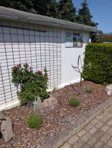 a garden in front of a building with a sign at Ferienhaus "Fritz" mit 3 Schlafzimmern in Seenähe in Löbnitz