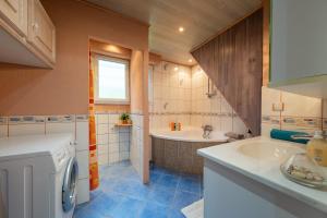 a bathroom with a tub and a sink and a bath tub at Chez Corinne in Cornimont +24 photos