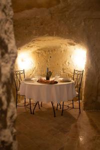 a table in a cave with a wine bottle and glasses at Lantray Secrète in Les-Trois-Moutiers +15 photos