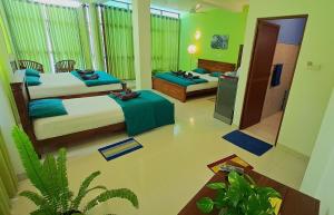 a hotel room with two beds and a television at Jagabay Resort & Surfing School in Weligama +237 photos