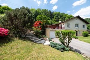a house with a staircase in front of a yard at Chez Corinne in Cornimont