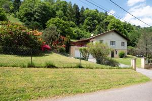 a house on a hill with a fence at Chalet Chez Corinne in Cornimont