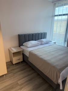 a bedroom with a large bed and a window at M&M Hotel in Pʼarakʼar