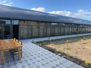 a patio with a table and a building with windows at M&M Hotel in Pʼarakʼar +3 photos