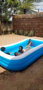 two people in a blue kayak in a backyard at Maasai Hostel Tanzania in Arusha