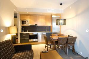 a kitchen and dining room with a table and chairs at Skistar Lodge Trysil in Trysil